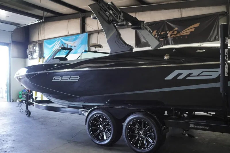 Slide: The Image of 2024 MB B52 23 Classic boat in a garage, showcasing sleek design and modern features. - 6