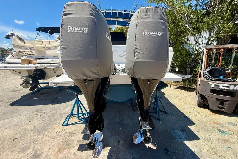 Slide: The Image of 2002 Intrepid 323 Cuddy with covered outboard motors on a sunny day. - 11