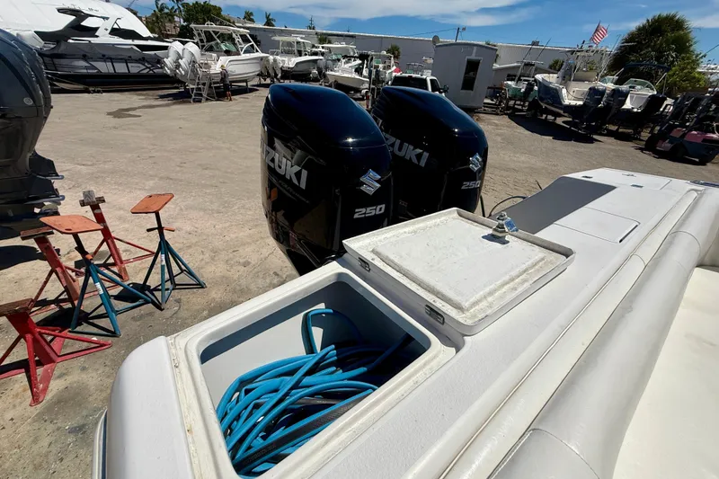 Slide: The Image of 2002 Intrepid 323 Cuddy with twin Suzuki 250 engines in a boatyard. - 12