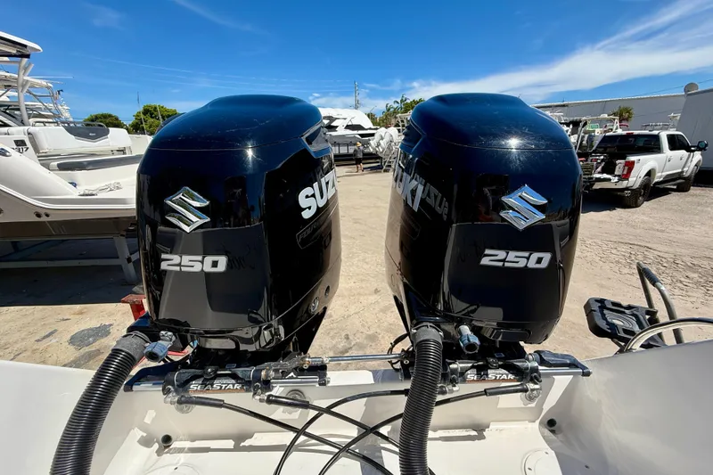 Slide: The Image of Twin Suzuki 250 outboard engines on a 2002 Intrepid 323 Cuddy boat. - 13
