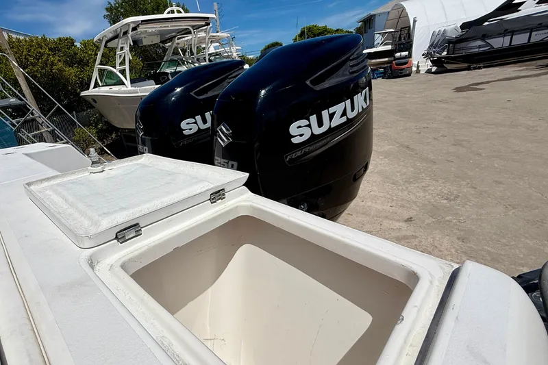 Slide: The Image of 2002 Intrepid 323 Cuddy with Suzuki outboard engines and open storage compartment. - 14
