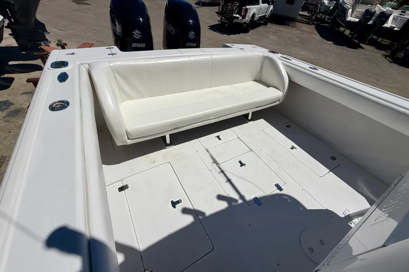 Slide: The Image of 2002 Intrepid 323 Cuddy boat interior with white seating and dual Suzuki 250 engines. - 17