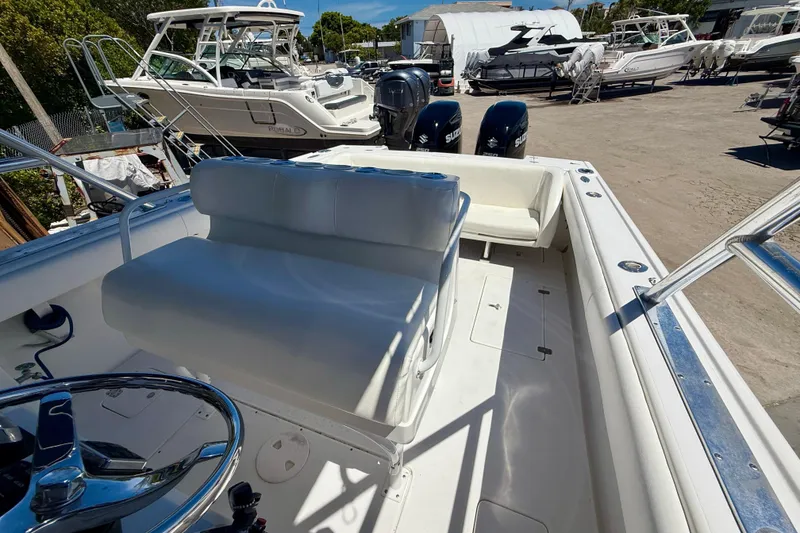 Slide: The Image of 2002 Intrepid 323 Cuddy boat interior with seating and dual outboard engines. - 22