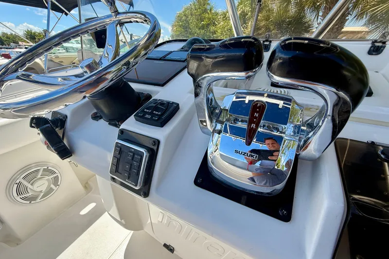 Slide: The Image of Helm of 2002 Intrepid 323 Cuddy with Suzuki controls and steering wheel. - 26