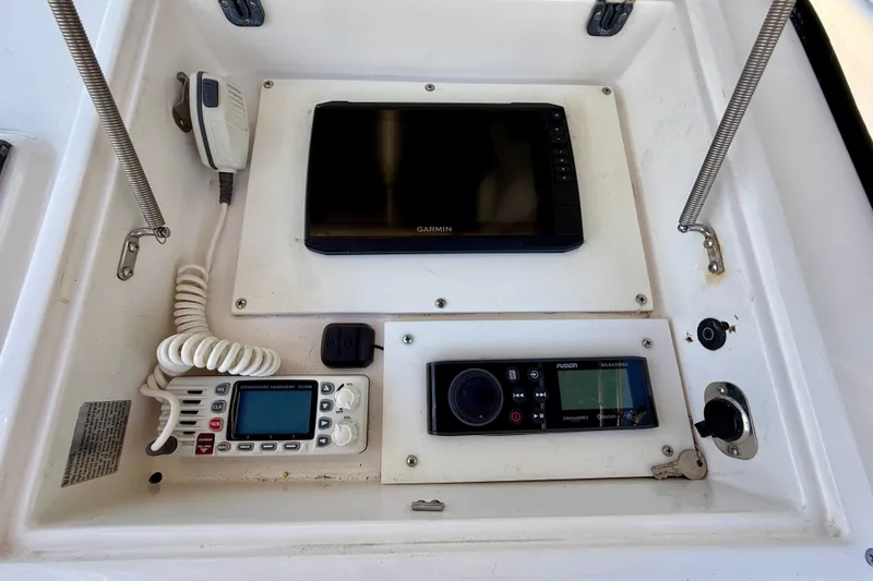 Slide: The Image of Boat dashboard with Garmin GPS, radio, and control panel on 2002 Intrepid 323 Cuddy. - 27