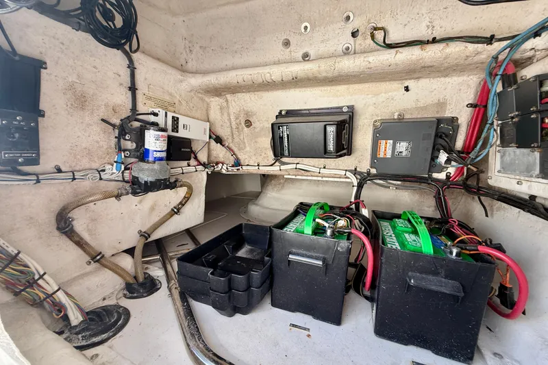 Slide: The Image of 2002 Intrepid 323 Cuddy boat interior showing electrical components and battery setup. - 31