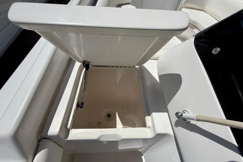 Slide: The Image of Open storage compartment on 2002 Intrepid 323 Cuddy boat, showing interior details. - 33