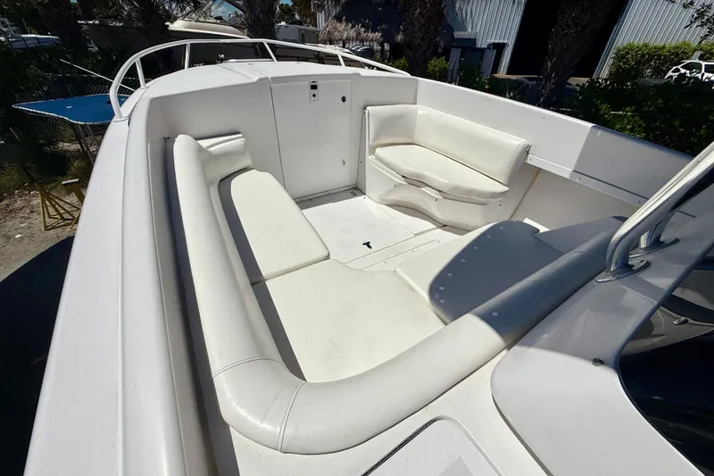 Slide: The Image of 2002 Intrepid 323 Cuddy boat interior with white seating and spacious layout. - 37