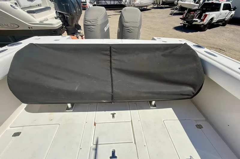 Slide: The Image of 2002 Intrepid 323 Cuddy boat deck with covered seating and outboard motors. - 42
