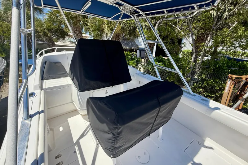 Slide: The Image of 2002 Intrepid 323 Cuddy boat interior with covered seating and canopy. - 45