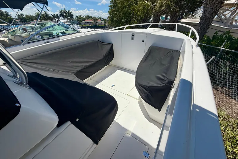 Slide: The Image of 2002 Intrepid 323 Cuddy boat interior with covered seating and open deck. - 46