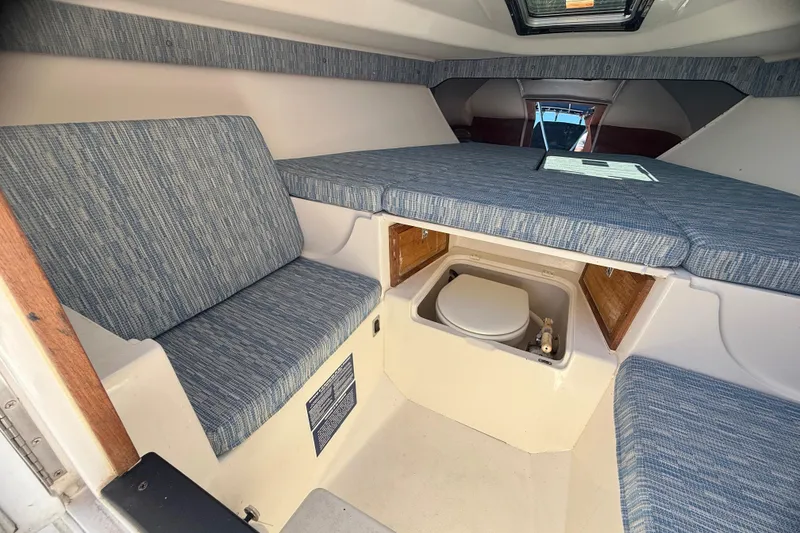 Slide: The Image of Interior of 2002 Intrepid 323 Cuddy with seating and compact toilet. - 49