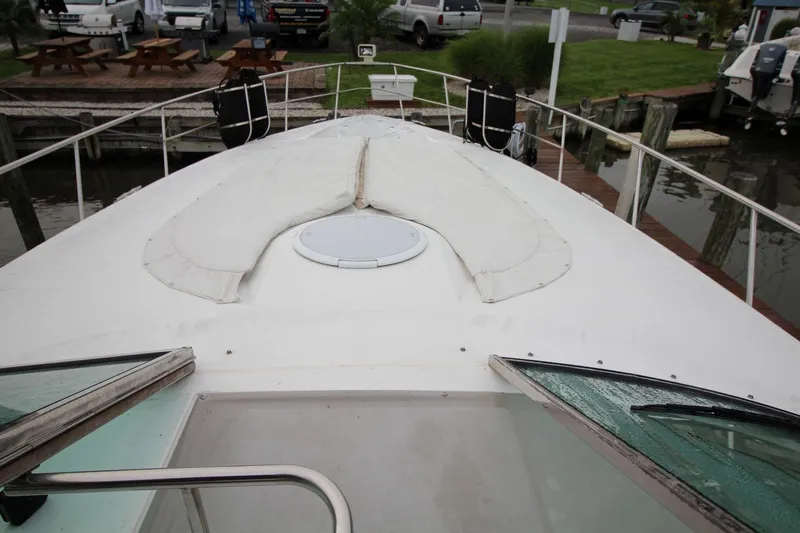 Slide: The Image of 2002 Cruisers Yachts 4270 Express boat deck with hatch, docked at marina. - 19