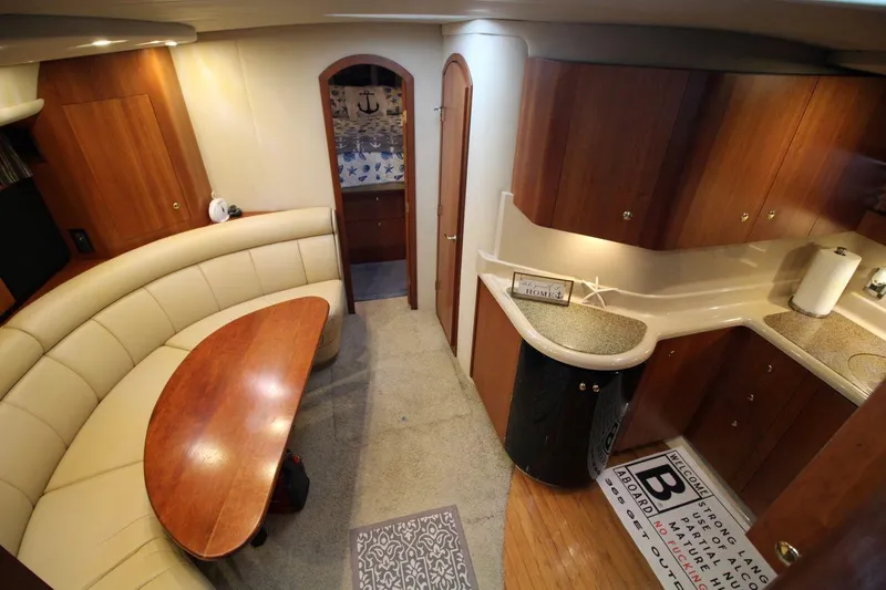 Slide: The Image of Luxurious interior of 2002 Cruisers Yachts 4270 Express with wood cabinetry and cozy seating. - 20