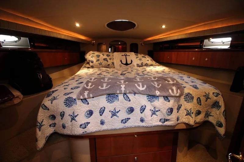 Slide: The Image of Luxurious 2002 Cruisers Yachts 4270 Express cabin with nautical-themed bedding. - 24