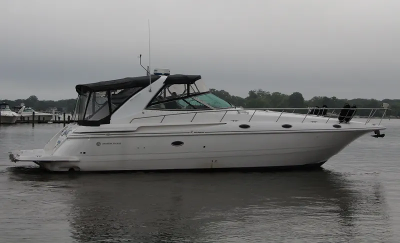 Slide: The Image of 2002 Cruisers Yachts 4270 Express on calm water, overcast sky. - 3