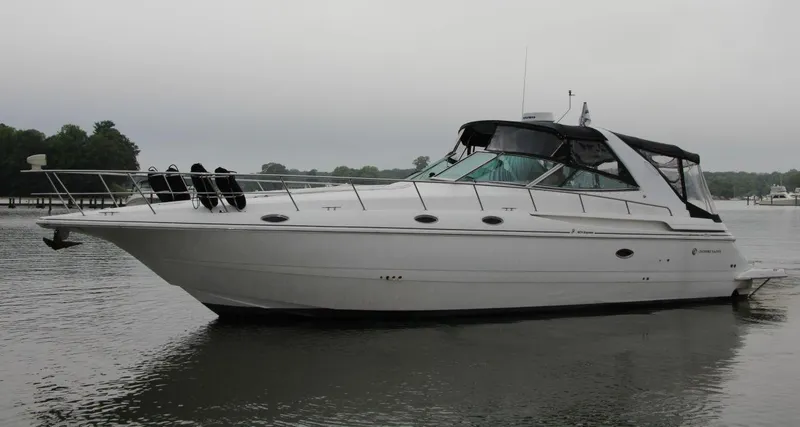 The Image of 2002 Cruisers Yachts 4270 Express on calm water, side view. - 0