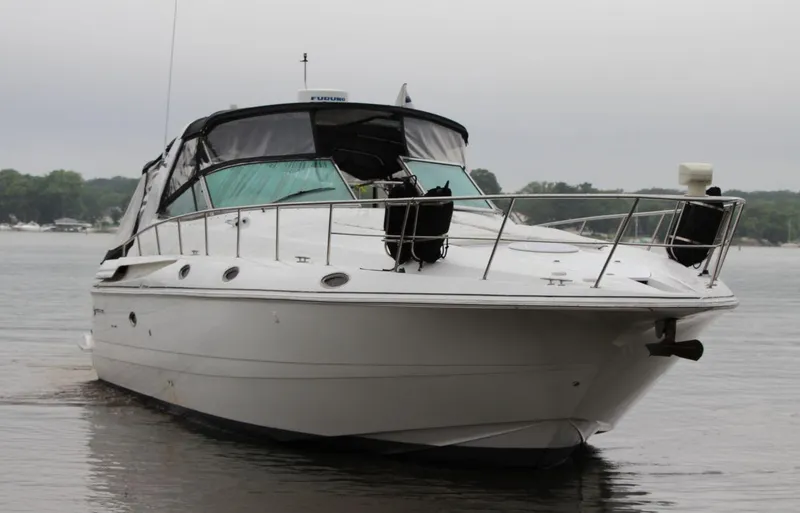 Slide: The Image of 2002 Cruisers Yachts 4270 Express on calm water, front view. - 12