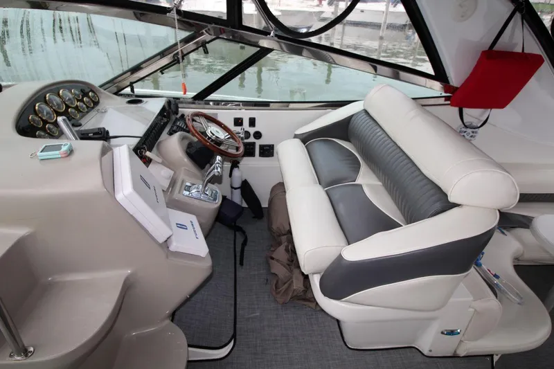 Slide: The Image of Interior of 2002 Cruisers Yachts 4270 Express with helm and seating area. - 17