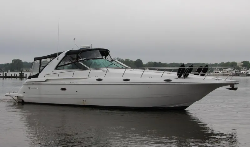 Slide: The Image of 2002 Cruisers Yachts 4270 Express on calm water, side view. - 2