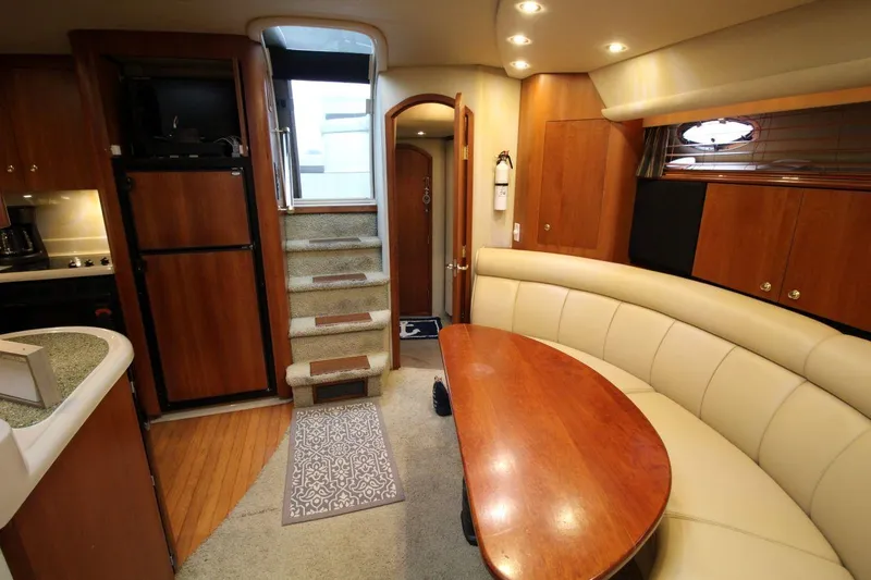 Slide: The Image of Luxurious interior of 2002 Cruisers Yachts 4270 Express with elegant seating and wooden finishes. - 22