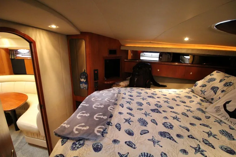Slide: The Image of Luxurious cabin interior of 2002 Cruisers Yachts 4270 Express with nautical-themed bedding. - 26