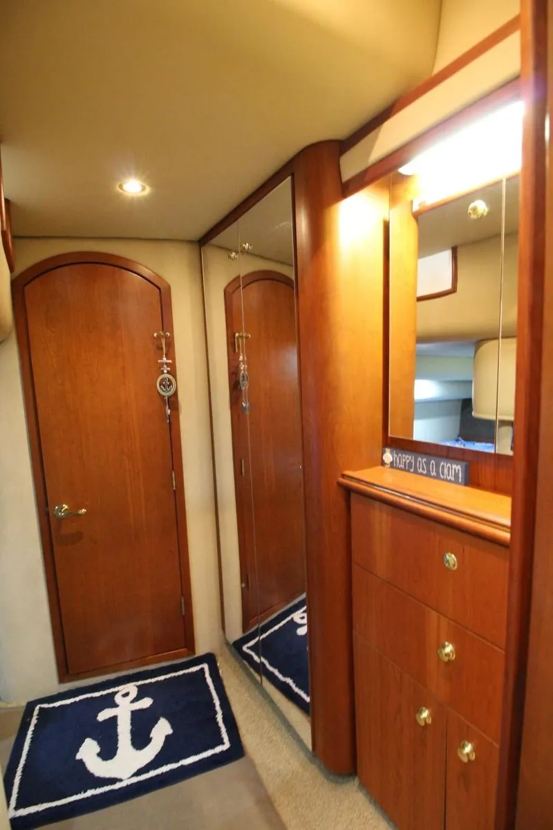 Slide: The Image of Luxurious interior of 2002 Cruisers Yachts 4270 Express with wooden cabinetry and nautical decor. - 29