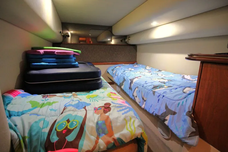Slide: The Image of Cozy twin beds in 2002 Cruisers Yachts 4270 Express cabin with colorful bedding. - 30
