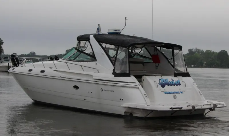 Slide: The Image of 2002 Cruisers Yachts 4270 Express on calm water, rear view with canopy. - 6