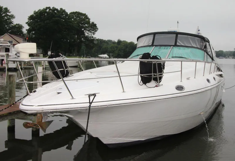 Slide: The Image of 2002 Cruisers Yachts 4270 Express docked on a calm lake. - 8