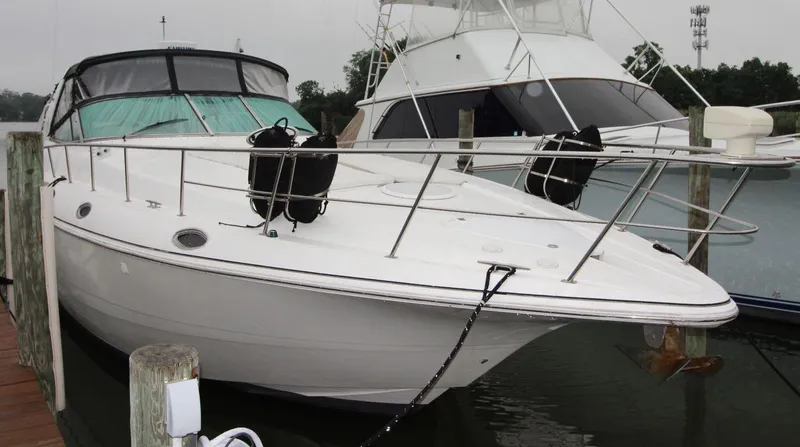 Slide: The Image of 2002 Cruisers Yachts 4270 Express docked at marina, front view. - 9