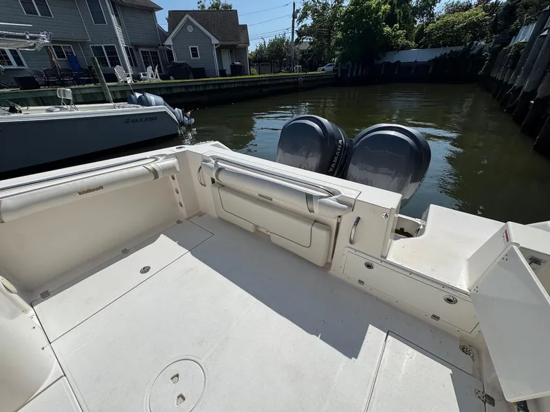 Slide: The Image of 2005 Wellcraft 290 Coastal boat with dual Yamaha outboard motors docked by waterfront homes. - 10