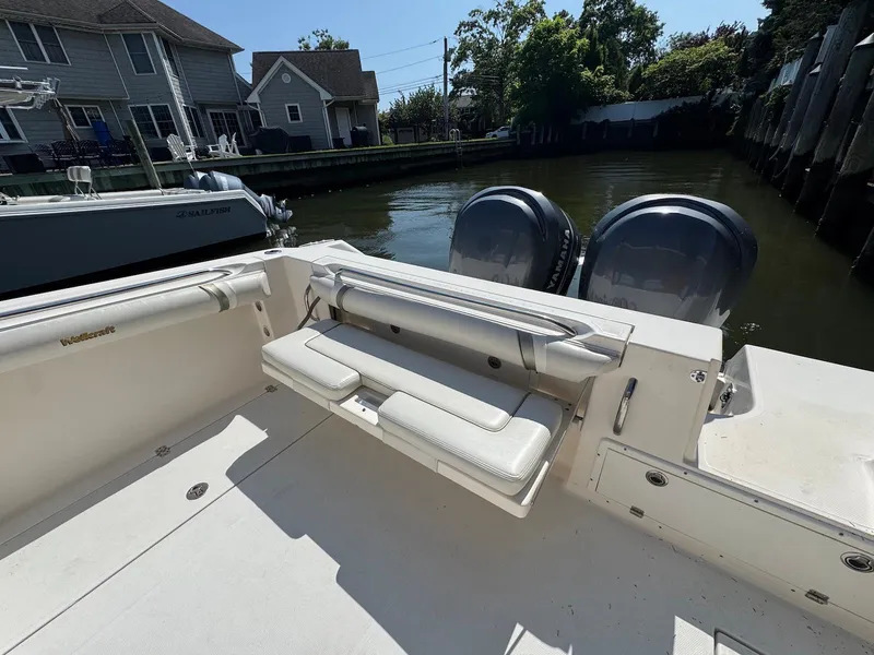 Slide: The Image of 2005 Wellcraft 290 Coastal boat with dual Yamaha engines docked by waterfront homes. - 11