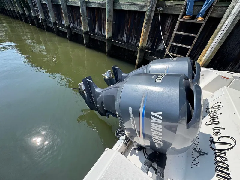 Slide: The Image of 2005 Wellcraft 290 Coastal boat with twin Yamaha outboard motors docked by wooden pier. - 12