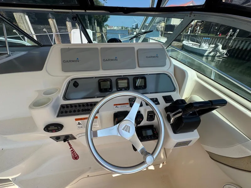 Slide: The Image of 2005 Wellcraft 290 Coastal boat helm with Garmin navigation system and steering wheel. - 13