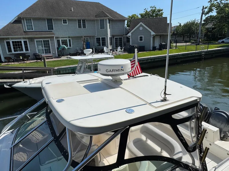 Slide: The Image of 2005 Wellcraft 290 Coastal boat docked near waterfront homes. - 18