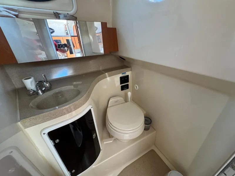 Slide: The Image of 2005 Wellcraft 290 Coastal boat bathroom with sink, toilet, and mirror. - 25