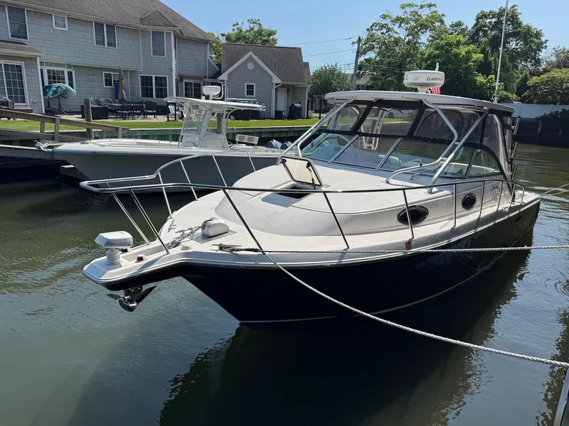 Slide: The Image of 2005 Wellcraft 290 Coastal boat docked near waterfront homes. - 3