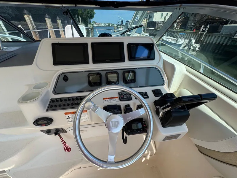 Slide: The Image of Helm of 2005 Wellcraft 290 Coastal boat with steering wheel and navigation controls. - 5