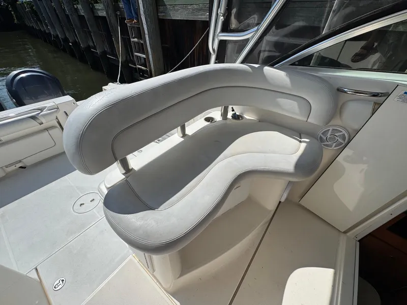 Slide: The Image of 2005 Wellcraft 290 Coastal boat interior with curved seating and speaker. - 7