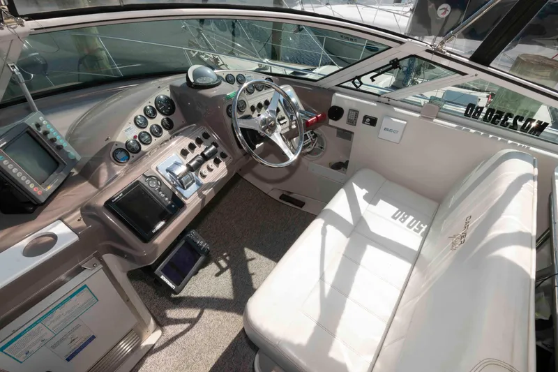 Slide: The Image of 1997 Carver 350 Mariner helm with steering wheel, gauges, and navigation equipment. - 11