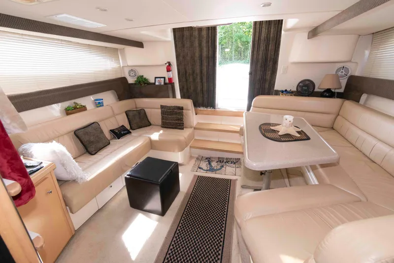 Slide: The Image of Luxurious interior of a 1997 Carver 350 Mariner yacht with beige seating and dining area. - 14