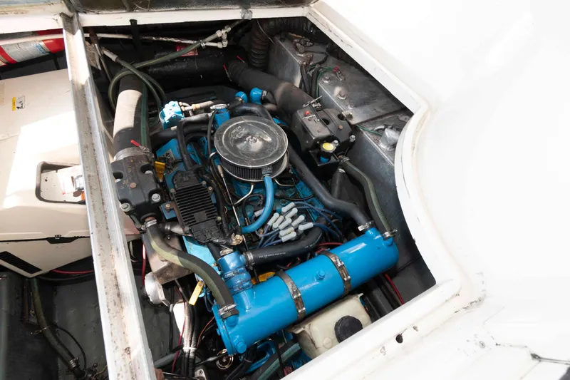 Slide: The Image of Engine compartment of a 1997 Carver 350 Mariner boat, showcasing mechanical components. - 23