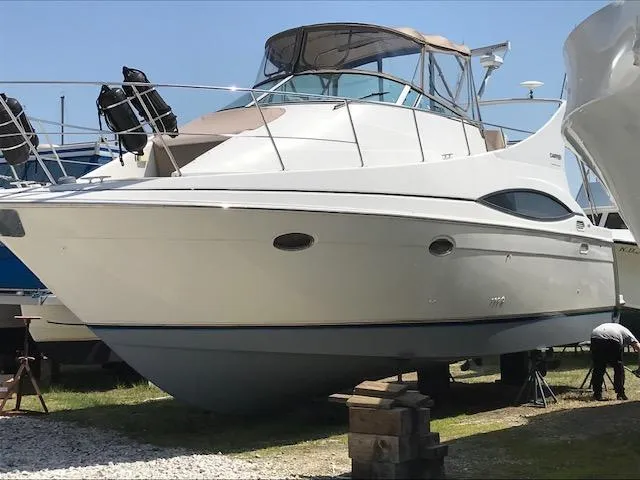 Slide: The Image of 1997 Carver 350 Mariner yacht on land, white hull, covered cockpit, sunny day. - 3