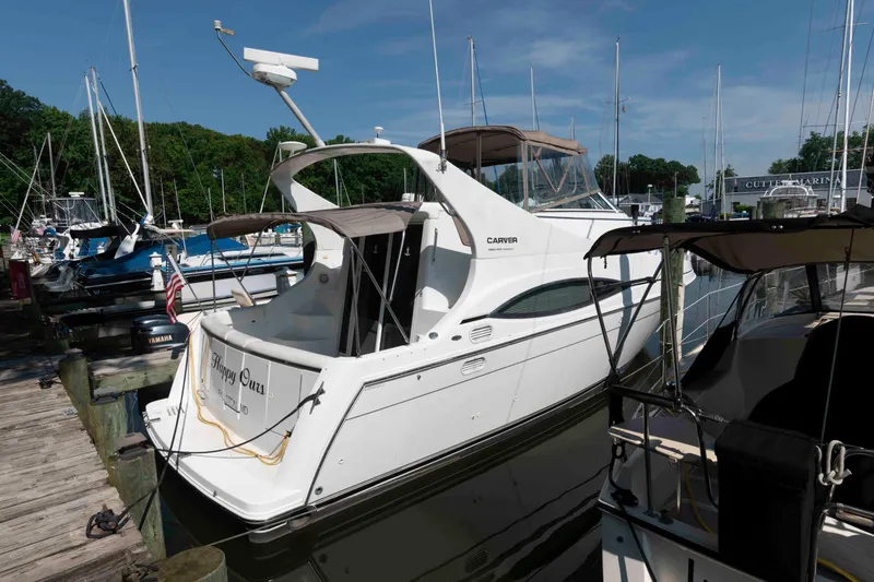 The Image of 1997 Carver 350 Mariner yacht docked at marina, surrounded by other boats. - 0