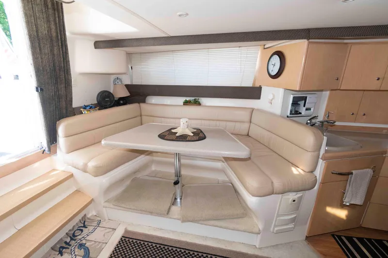 Slide: The Image of Interior of 1997 Carver 350 Mariner yacht with cozy seating and dining area. - 15