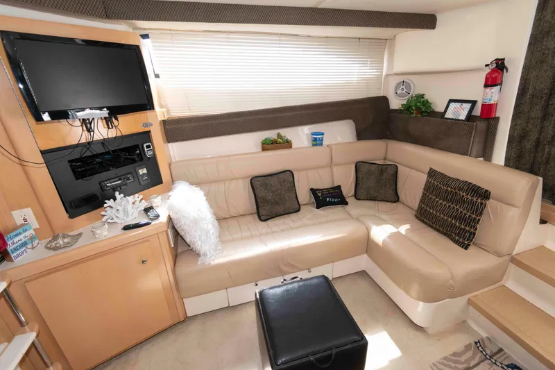 Slide: The Image of Luxurious interior of 1997 Carver 350 Mariner yacht with beige leather seating and entertainment system. - 16