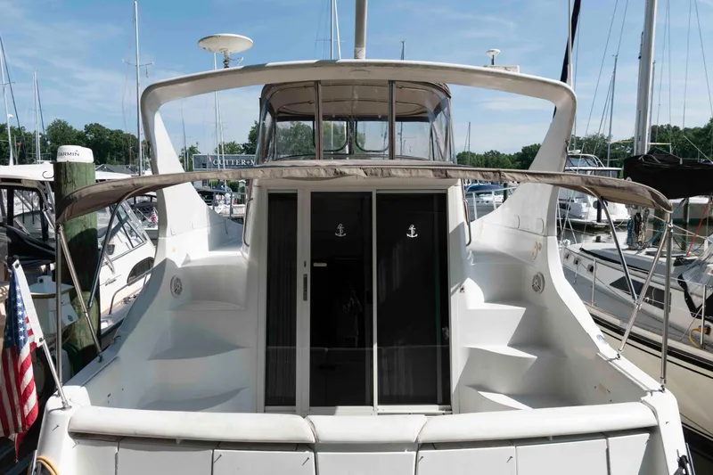 Slide: The Image of 1997 Carver 350 Mariner yacht docked at marina, rear view with open deck. - 2