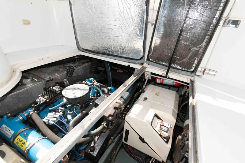 Slide: The Image of Engine compartment of a 1997 Carver 350 Mariner boat, showcasing mechanical components. - 21