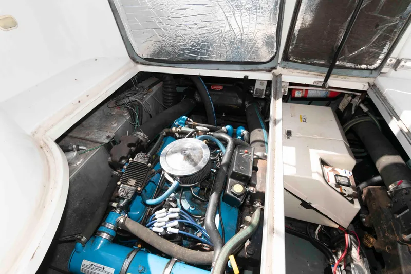 Slide: The Image of Engine compartment of a 1997 Carver 350 Mariner boat, showcasing mechanical components. - 22